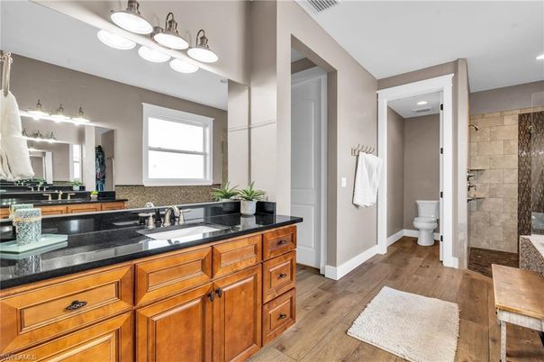 Bathroom, Dual Sink Vanities, Interior, Recessed Lighting, Stone Walls, Wood Texture Flooring