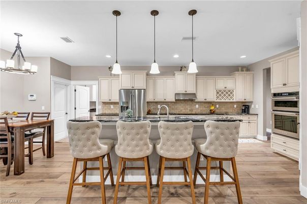 Dining room, Interior, Kitchen, Pendant Lights, Recessed Lighting, Stainless Steel Appliances, Wood Texture Flooring