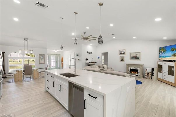 Dining room, Fireplace, Interior, Kitchen, Living room, Pendant Lights, Recessed Lighting, Stainless Steel Appliances, Wood Texture Flooring