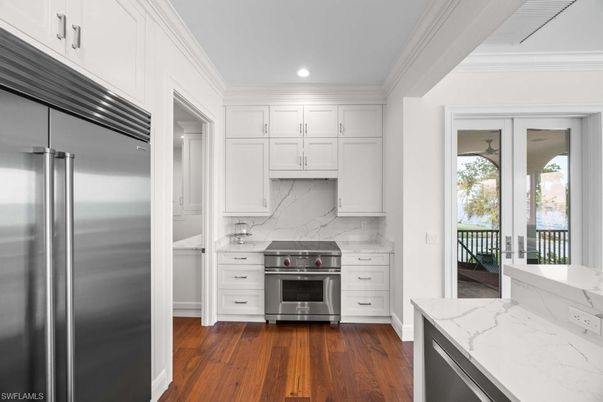 Interior, Kitchen, Marble Walls, Recessed Lighting, Stainless Steel Appliances, Wood Texture Flooring