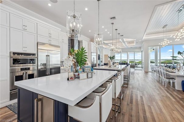 Chandelier, Dining room, Interior, Kitchen, Living room, Pendant Lights, Recessed Lighting, Stainless Steel Appliances, Wood Texture Flooring