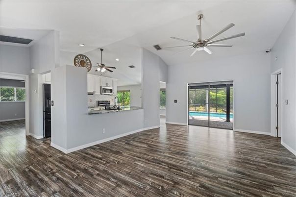 Empty room, Interior, Kitchen, Recessed Lighting, Stainless Steel Appliances, Wood Texture Flooring