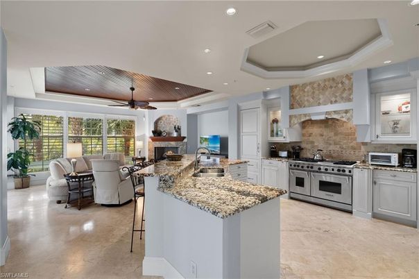 Dining room, Fireplace, Interior, Kitchen, Living room, Recessed Lighting, Stainless Steel Appliances, Stone Walls, Wooden Ceilings