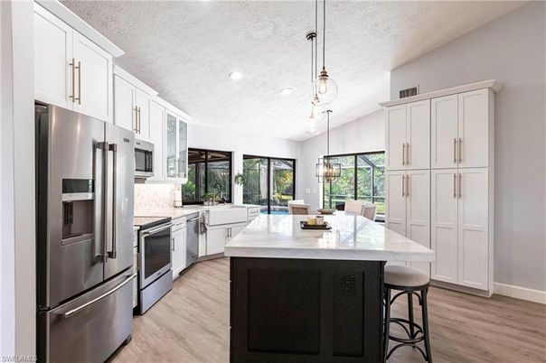 Dining room, Interior, Kitchen, Pendant Lights, Recessed Lighting, Stainless Steel Appliances, Wood Texture Flooring