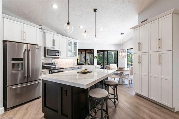 Dining room, Interior, Kitchen, Pendant Lights, Recessed Lighting, Stainless Steel Appliances, Wood Texture Flooring