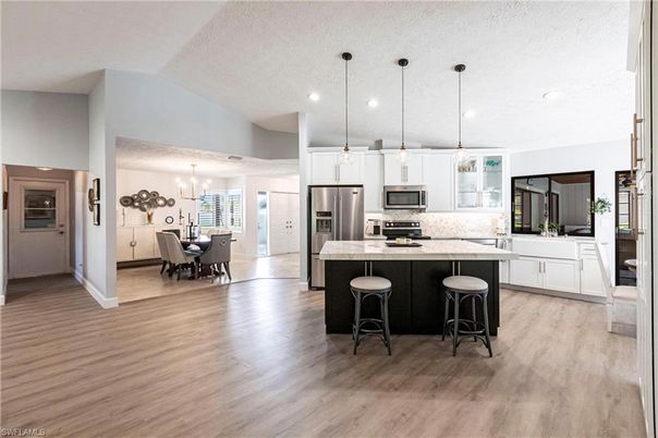 Chandelier, Dining room, Interior, Kitchen, Pendant Lights, Recessed Lighting, Stainless Steel Appliances, Wood Texture Flooring