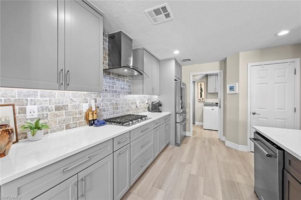 Interior, Kitchen, Recessed Lighting, Stainless Steel Appliances, Washer, Wood Texture Flooring