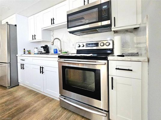 Interior, Kitchen, Marble Walls, Stainless Steel Appliances, Wood Texture Flooring