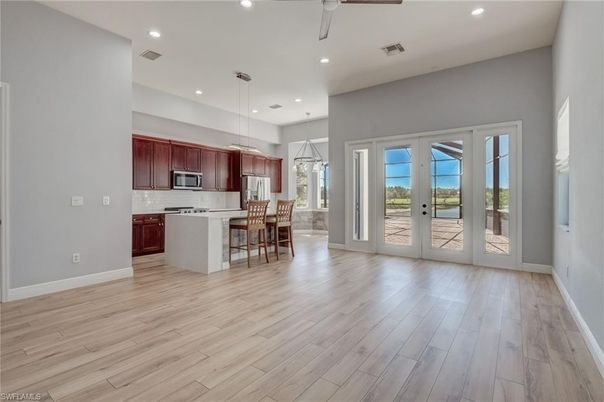 Dining room, Interior, Kitchen, Pendant Lights, Recessed Lighting, Stainless Steel Appliances, Wood Texture Flooring