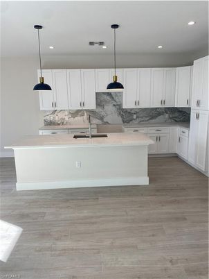 Interior, Kitchen, Marble Walls, Pendant Lights, Recessed Lighting, Wood Texture Flooring