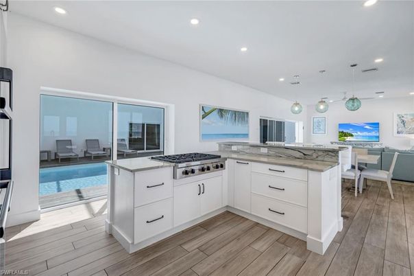 Dining room, Interior, Kitchen, Pendant Lights, Recessed Lighting, Stainless Steel Appliances, Water, Wood Texture Flooring