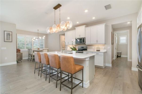 Dining room, Interior, Kitchen, Pendant Lights, Recessed Lighting, Stainless Steel Appliances, Wood Texture Flooring