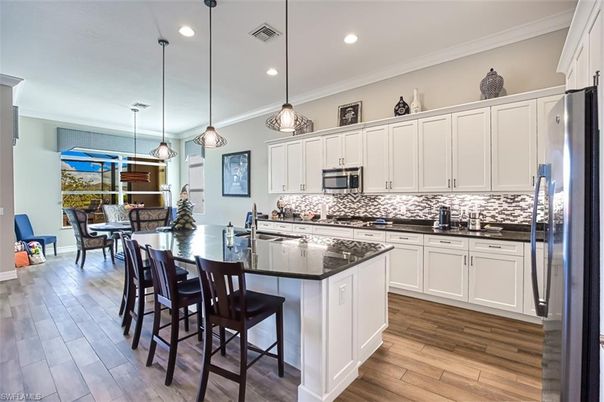 Dining room, Interior, Kitchen, Pendant Lights, Recessed Lighting, Stainless Steel Appliances, Wood Texture Flooring