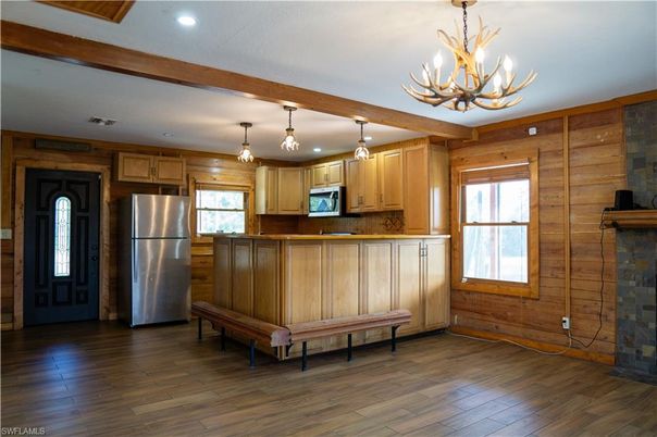 Chandelier, Interior, Kitchen, Recessed Lighting, Stainless Steel Appliances, Wood Texture Flooring, Wooden Walls