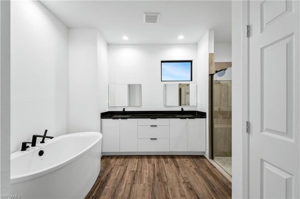 Bathroom, Dual Sink Vanities, Free Standing Baths, Glass Shower, Interior, Recessed Lighting, Wood Texture Flooring