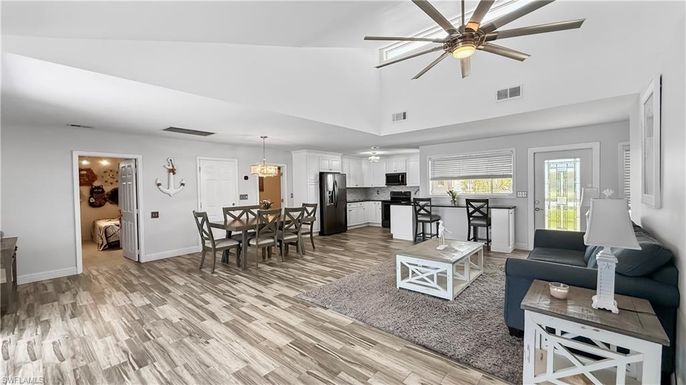 Chandelier, Dining room, Interior, Kitchen, Living room, Pendant Lights, Stainless Steel Appliances, Wood Texture Flooring