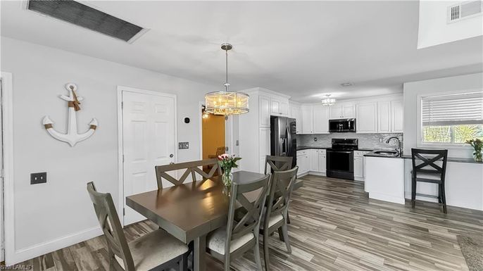 Chandelier, Dining room, Interior, Kitchen, Pendant Lights, Stainless Steel Appliances, Wood Texture Flooring