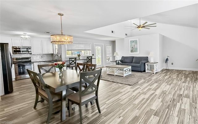 Chandelier, Dining room, Interior, Kitchen, Living room, Pendant Lights, Stainless Steel Appliances, Wood Texture Flooring