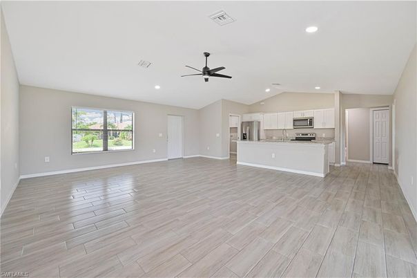 Empty room, Interior, Kitchen, Recessed Lighting, Stainless Steel Appliances, Wood Texture Flooring