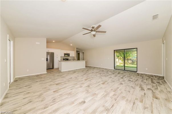 Empty room, Interior, Kitchen, Recessed Lighting, Stainless Steel Appliances, Wood Texture Flooring