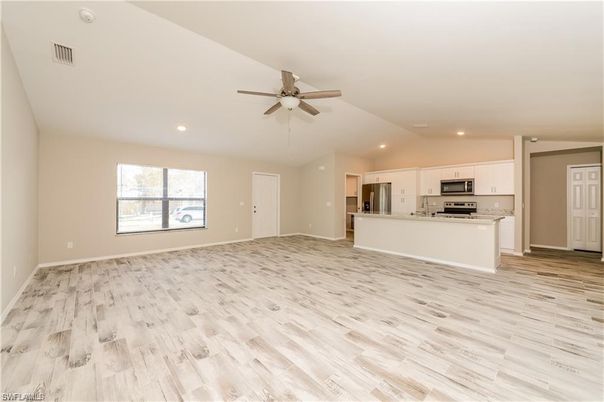 Empty room, Interior, Kitchen, Recessed Lighting, Stainless Steel Appliances, Wood Texture Flooring