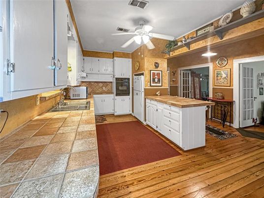 Interior, Kitchen, Recessed Lighting, Tile Countertops, Wood Texture Flooring