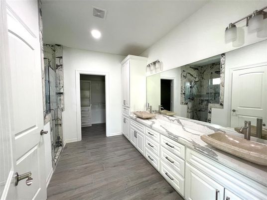 Bathroom, Dual Sink Vanities, Glass Shower, Interior, Marble Walls, Recessed Lighting, Wood Texture Flooring