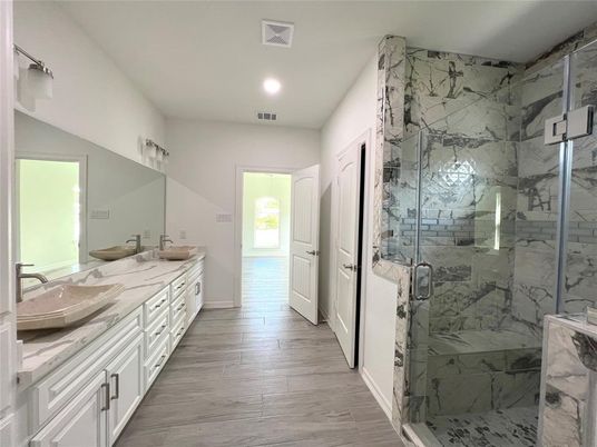 Bathroom, Dual Sink Vanities, Glass Shower, Interior, Marble Walls, Recessed Lighting, Wood Texture Flooring