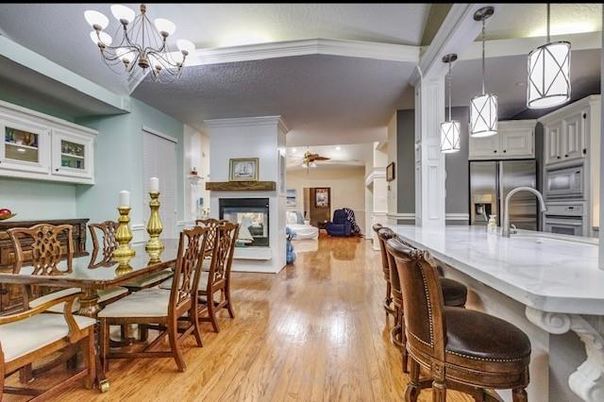Chandelier, Dining room, Fireplace, Interior, Kitchen, Living room, Pendant Lights, Stainless Steel Appliances, Wood Texture Flooring