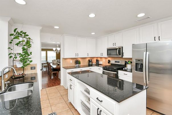 Chandelier, Dining room, Interior, Kitchen, Recessed Lighting, Stainless Steel Appliances, Wood Texture Flooring