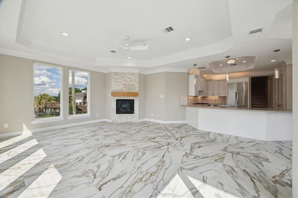 Empty room, Fireplace, Interior, Kitchen, Marble, Recessed Lighting, Stainless Steel Appliances