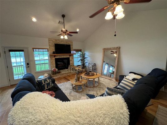 Fireplace, Interior, Living room, Recessed Lighting, Stone Walls, Wood Texture Flooring