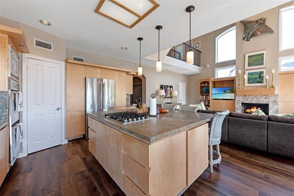 Fireplace, Interior, Kitchen, Living room, Pendant Lights, Recessed Lighting, Stainless Steel Appliances, Wood Texture Flooring