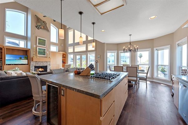 Chandelier, Dining room, Fireplace, Interior, Kitchen, Living room, Pendant Lights, Recessed Lighting, Stainless Steel Appliances, Wood Texture Flooring