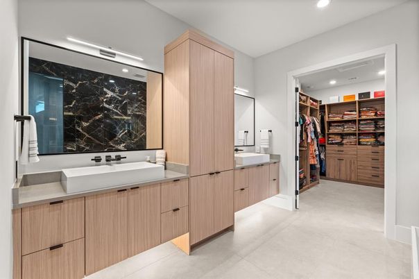 Bathroom, Dual Sink Vanities, Interior, Marble Walls, Recessed Lighting, Walk-in Closets