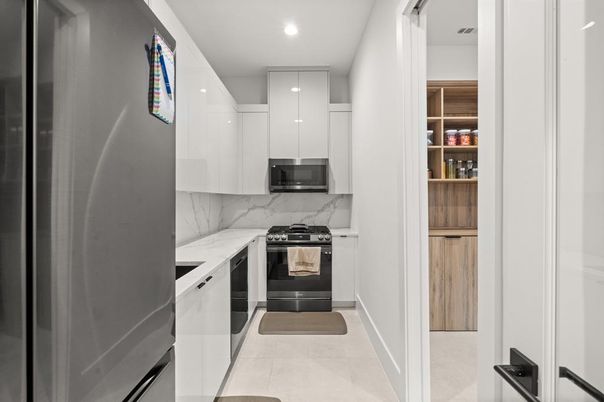 Interior, Kitchen, Marble Walls, Recessed Lighting, Stainless Steel Appliances