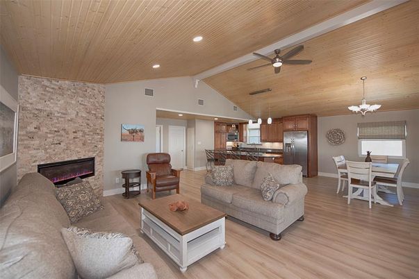 Dining room, Fireplace, Interior, Kitchen, Living room, Pendant Lights, Recessed Lighting, Stainless Steel Appliances, Stone Walls, Wooden Ceilings, Wood Texture Flooring