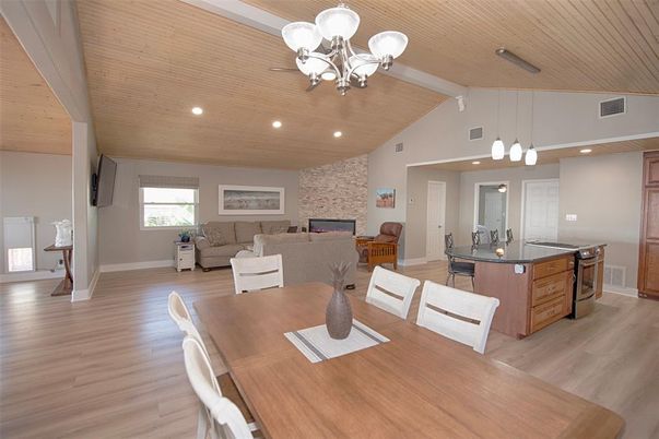 Chandelier, Dining room, Fireplace, Interior, Kitchen, Living room, Pendant Lights, Recessed Lighting, Stone Walls, Wooden Ceilings, Wood Texture Flooring