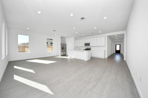 Empty room, Interior, Kitchen, Recessed Lighting, Stainless Steel Appliances, Wood Texture Flooring