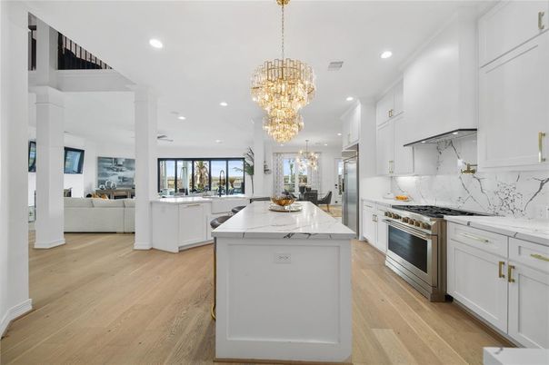 Chandelier, Interior, Kitchen, Living room, Marble Walls, Recessed Lighting, Stainless Steel Appliances, Wood Texture Flooring