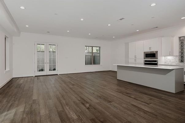 Empty room, Interior, Kitchen, Recessed Lighting, Stainless Steel Appliances, Wood Texture Flooring