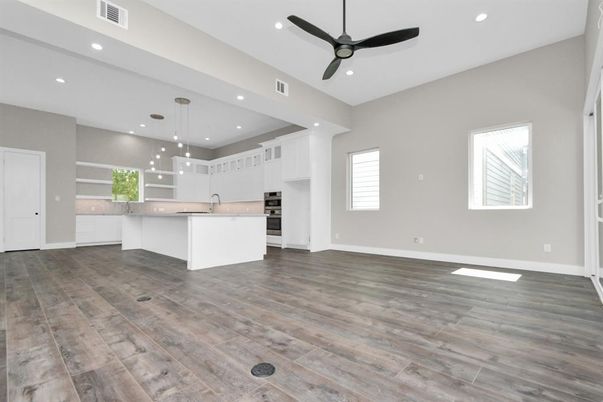 Empty room, Interior, Kitchen, Pendant Lights, Recessed Lighting, Stainless Steel Appliances, Wood Texture Flooring