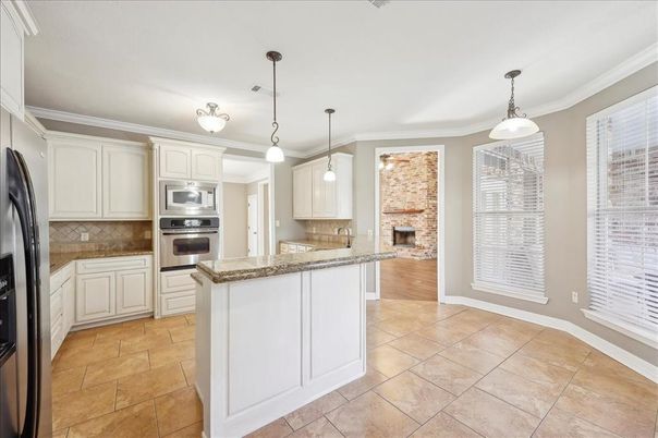 Fireplace, Interior, Kitchen, Pendant Lights, Stainless Steel Appliances, Stone Walls