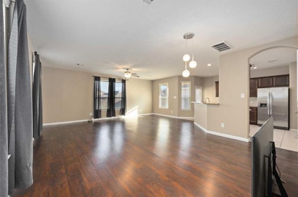 Empty room, Interior, Kitchen, Pendant Lights, Recessed Lighting, Stainless Steel Appliances, Wood Texture Flooring