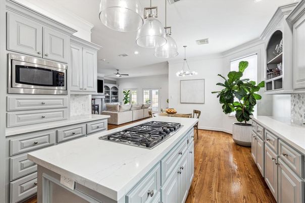 Chandelier, Dining room, Interior, Kitchen, Living room, Pendant Lights, Recessed Lighting, Stainless Steel Appliances, Wood Texture Flooring