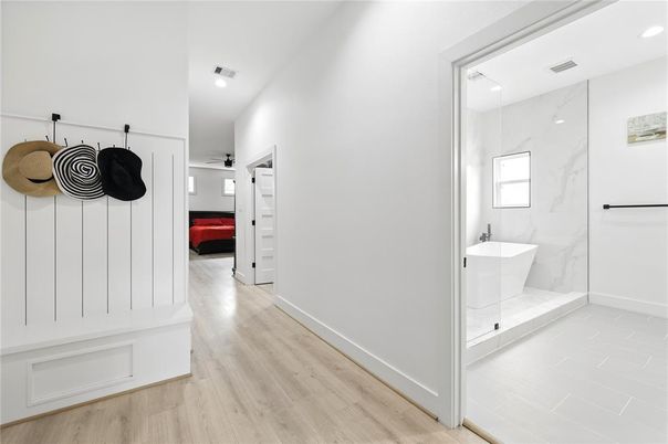 Bathroom, Free Standing Baths, Interior, Marble Walls, Recessed Lighting, Wood Texture Flooring