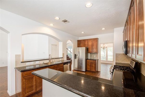 Chandelier, Interior, Kitchen, Recessed Lighting, Stainless Steel Appliances, Wood Texture Flooring
