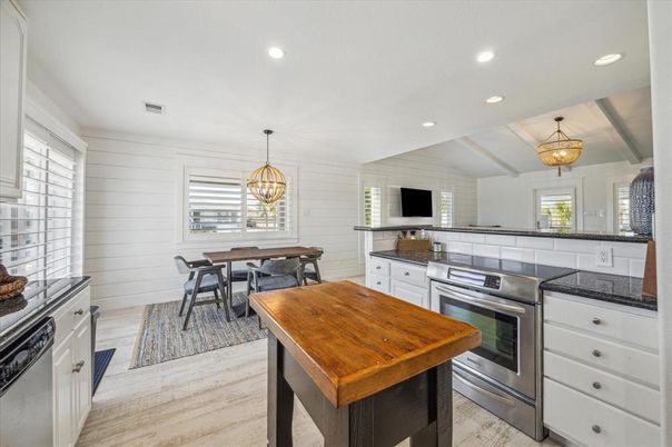 Chandelier, Dining room, Interior, Kitchen, Pendant Lights, Recessed Lighting, Stainless Steel Appliances, Wood Texture Flooring