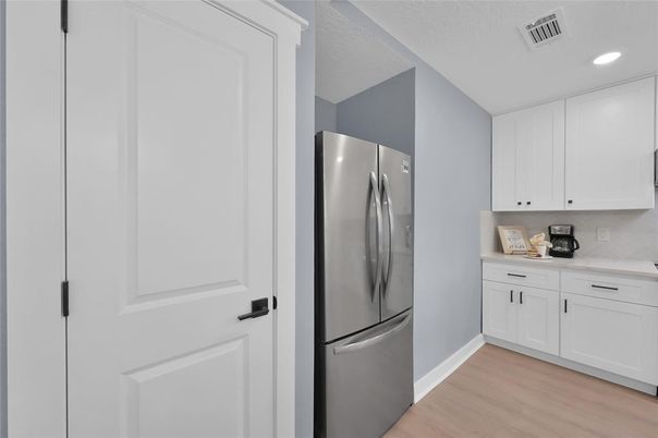 Interior, Kitchen, Recessed Lighting, Washer, Wood Texture Flooring