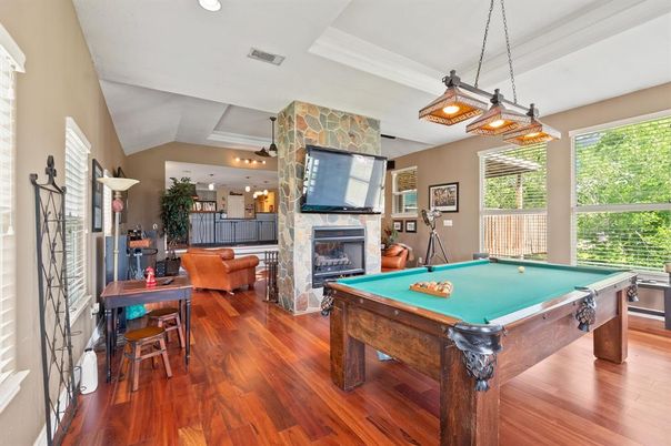 Billiard Table, Fireplace, Game Room, Interior, Living room, Pendant Lights, Recessed Lighting, Stone Walls, Wood Texture Flooring